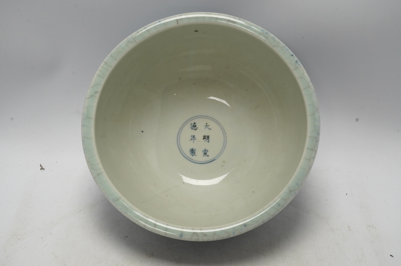 A large Chinese blue and white ‘dragon’ bowl decorated in low relief, 28cm in diameter. Condition - good